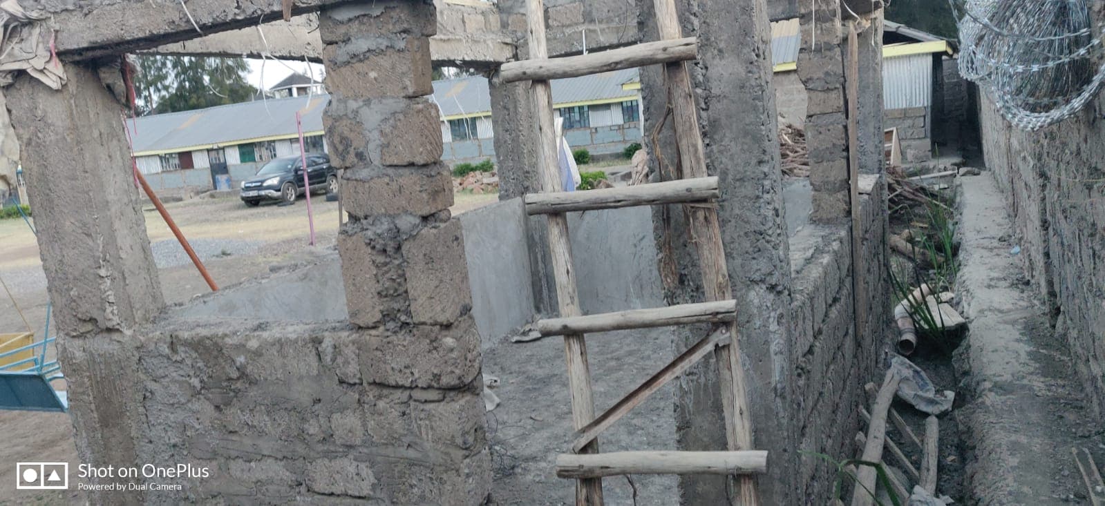 Walls rising, timber props and ladder in place