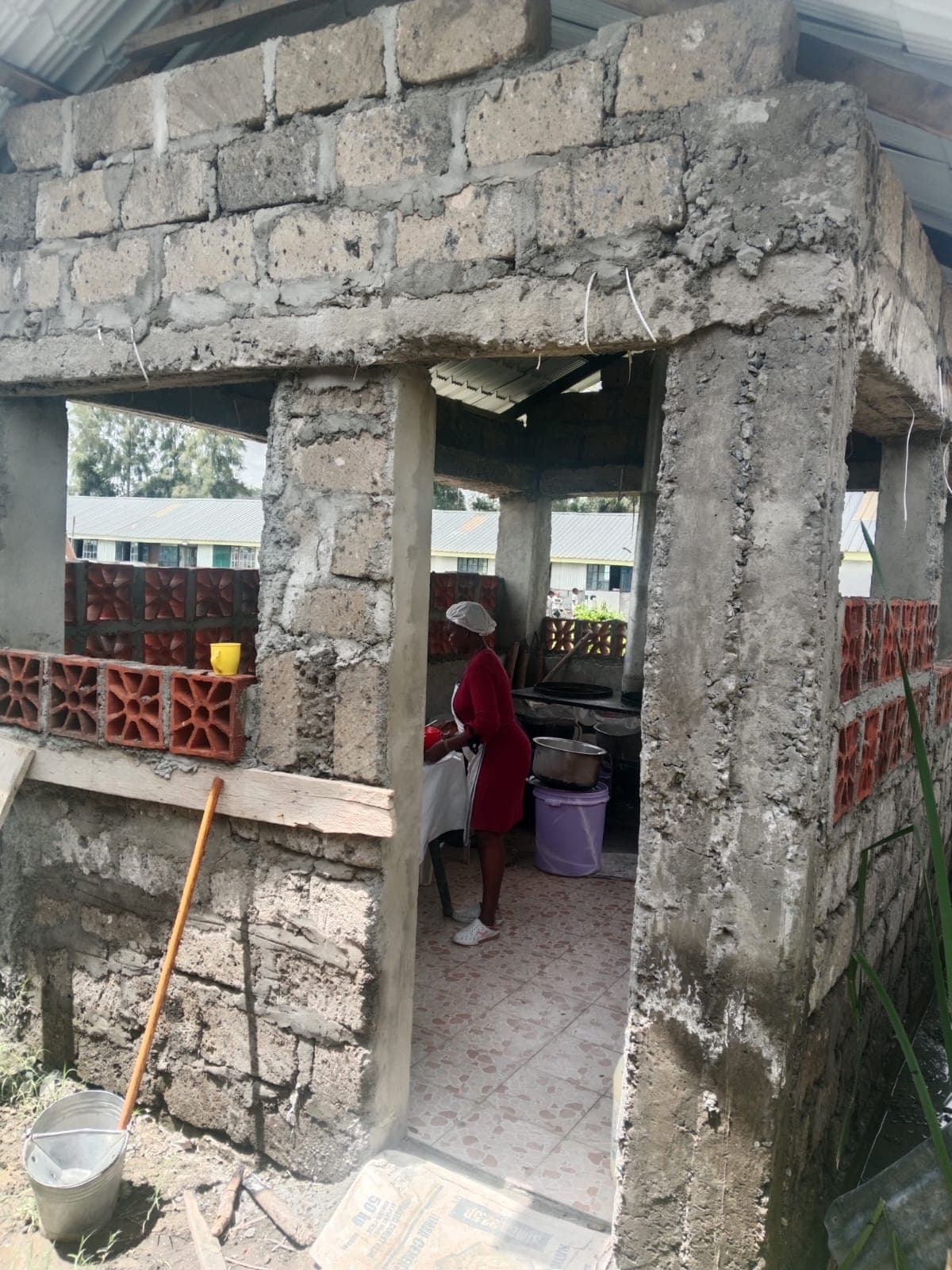 In the doorway, with cooking underway inside