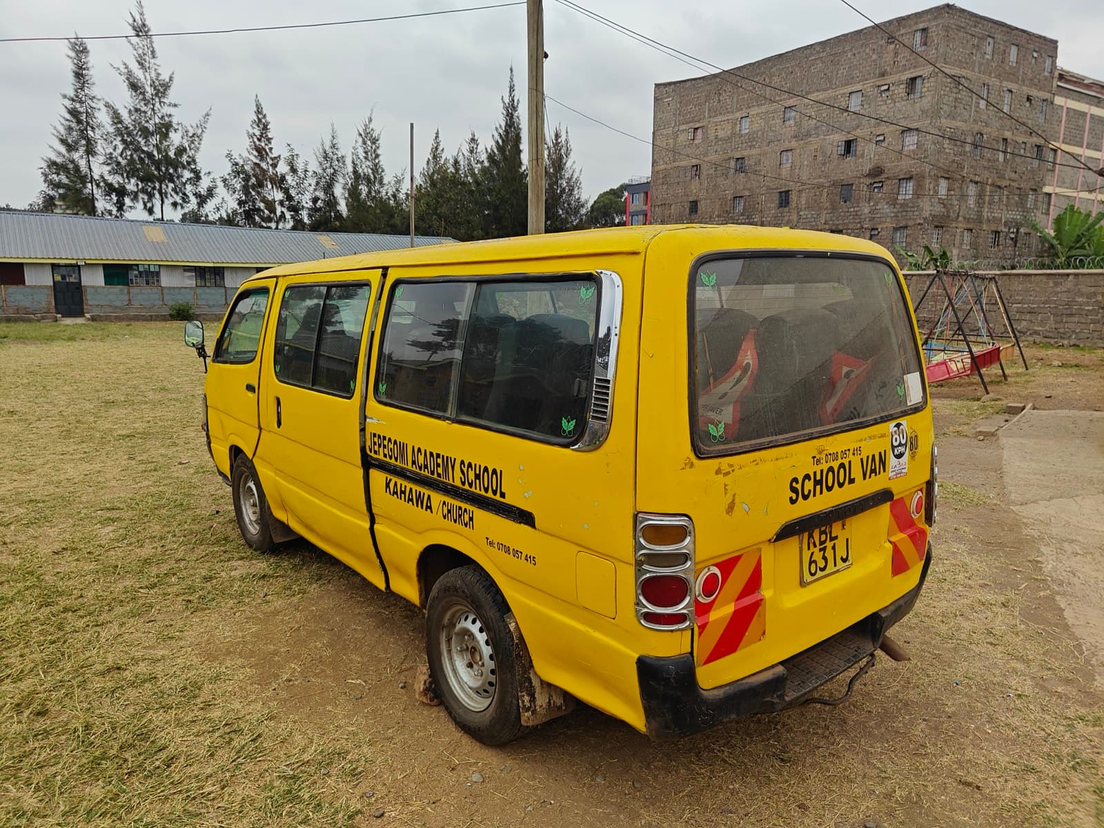 The same van standing at the edge of the school field, out of service